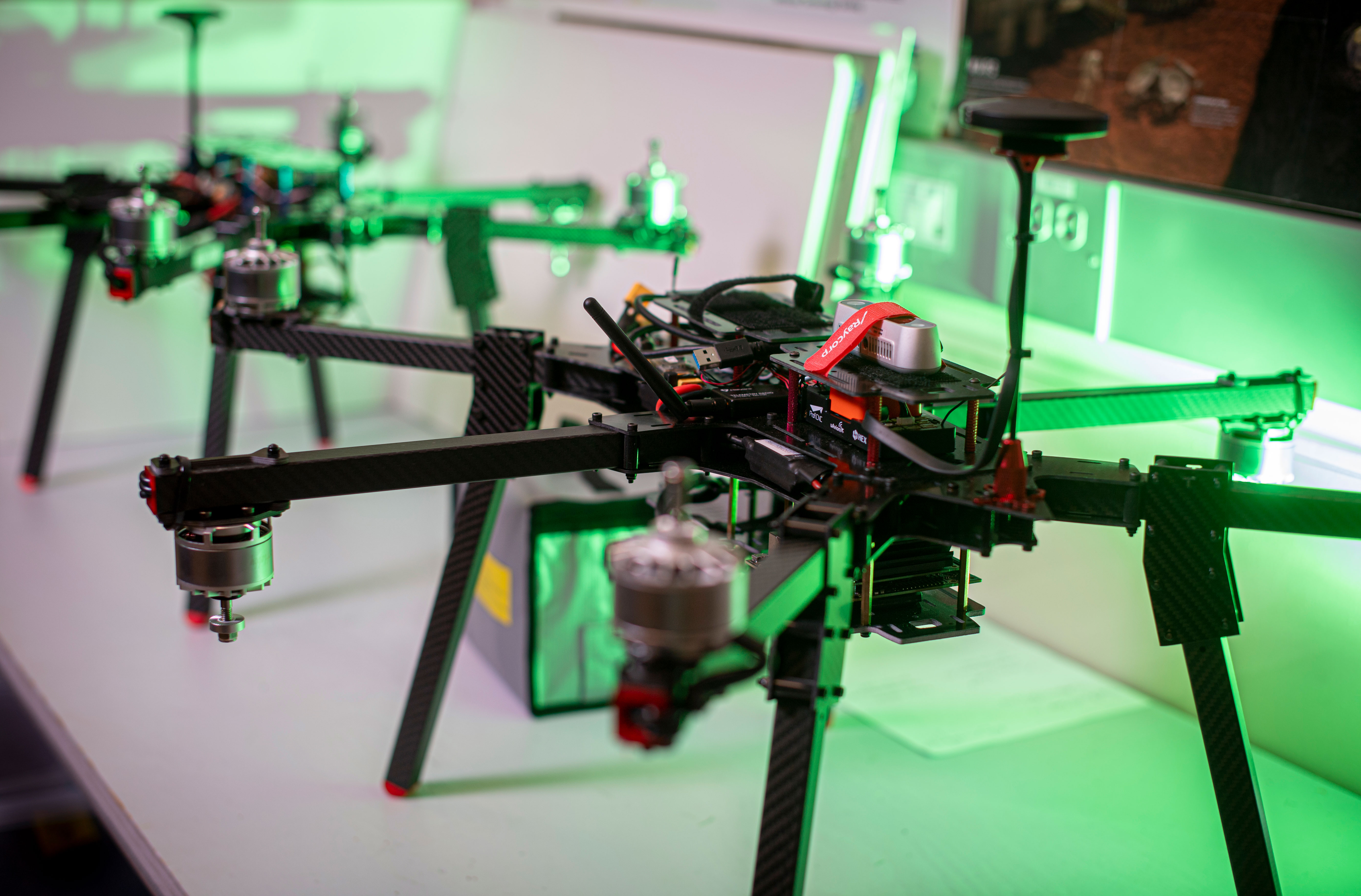 Photo of drones on a table with a green light in the background