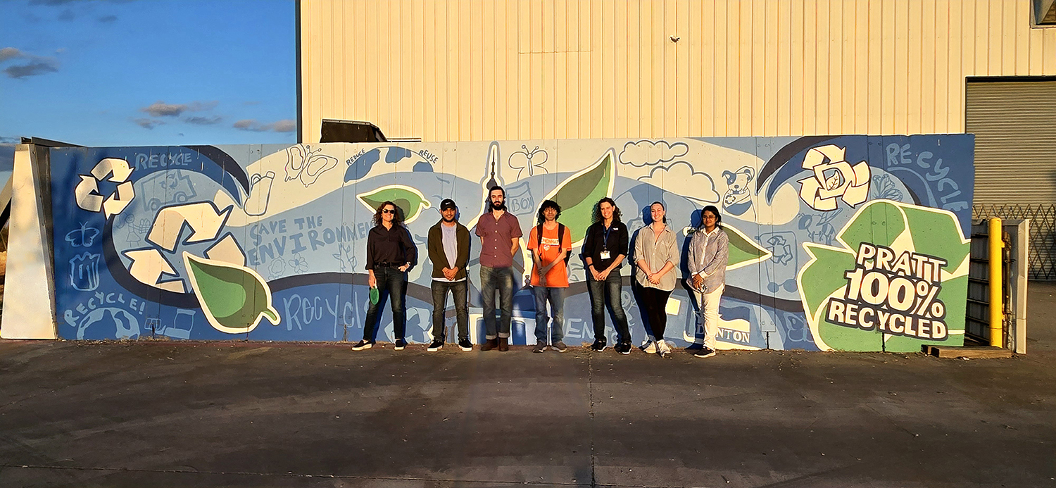 Photo of UNT anthropology faculty member and students in front of recycling facility.