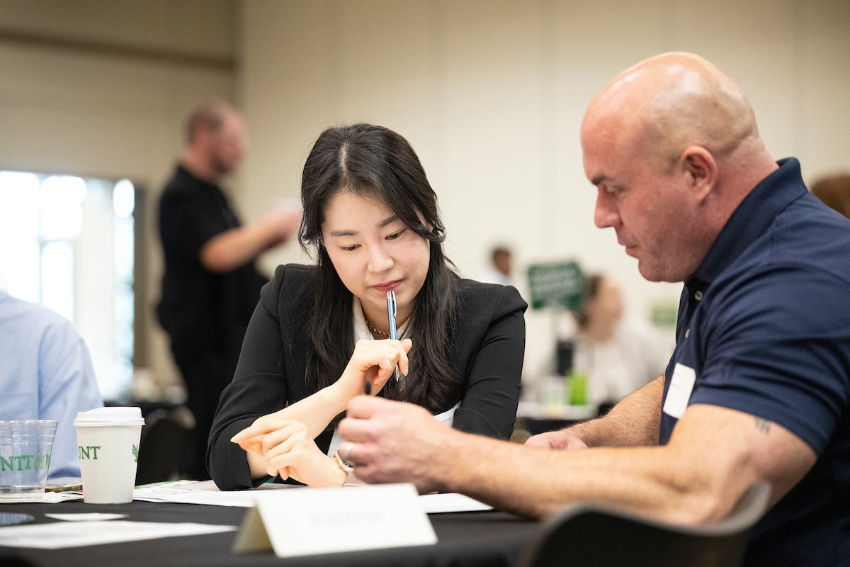 researchers going over work at conference