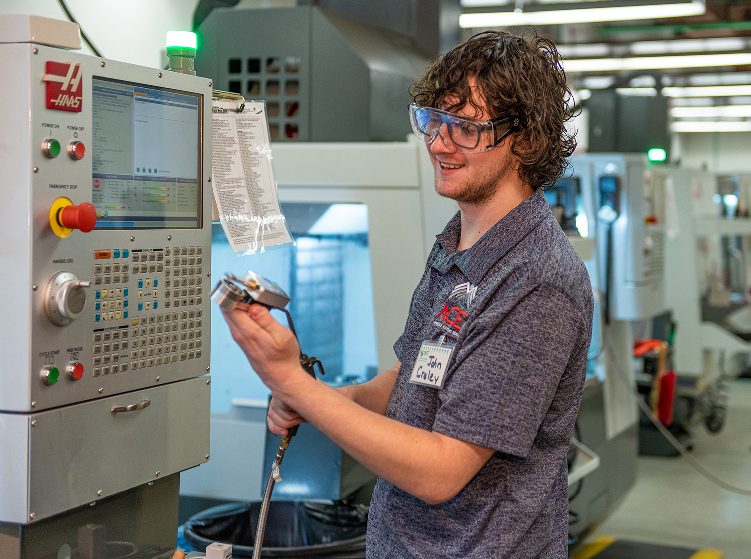 Photo of UNT student  John Creley using a machine during an ACE Bootcamp