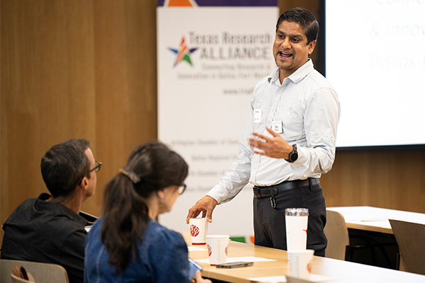 Attendees talk at AI event in Frisco