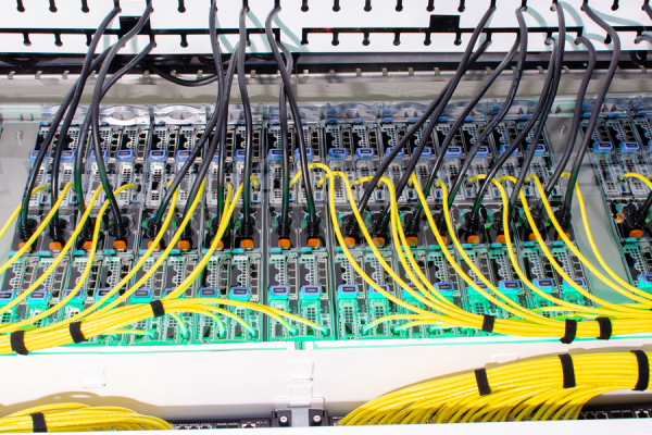 photo of multiple connected computers; many colorful wires