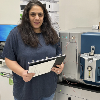 Photo of woman (Yasmeen Elharis) working in a lab