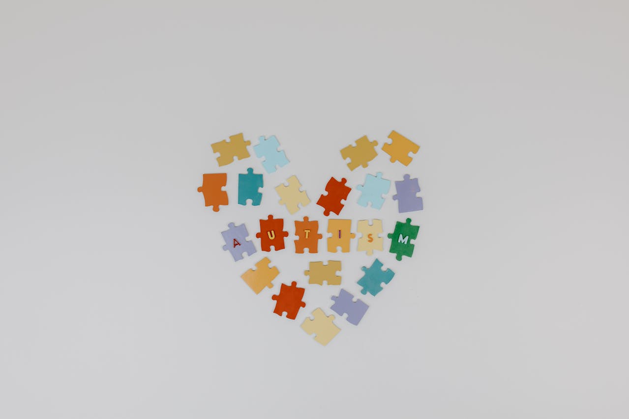 Stock photo of heart made of of puzzle pieces and spelling out autism