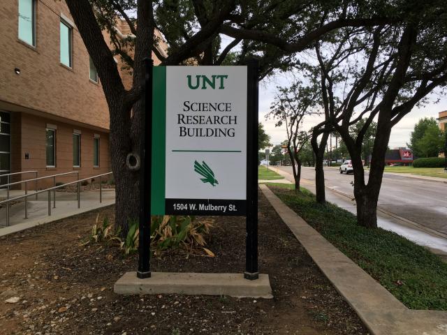 Photo of a building sign that says "Science Research Building"