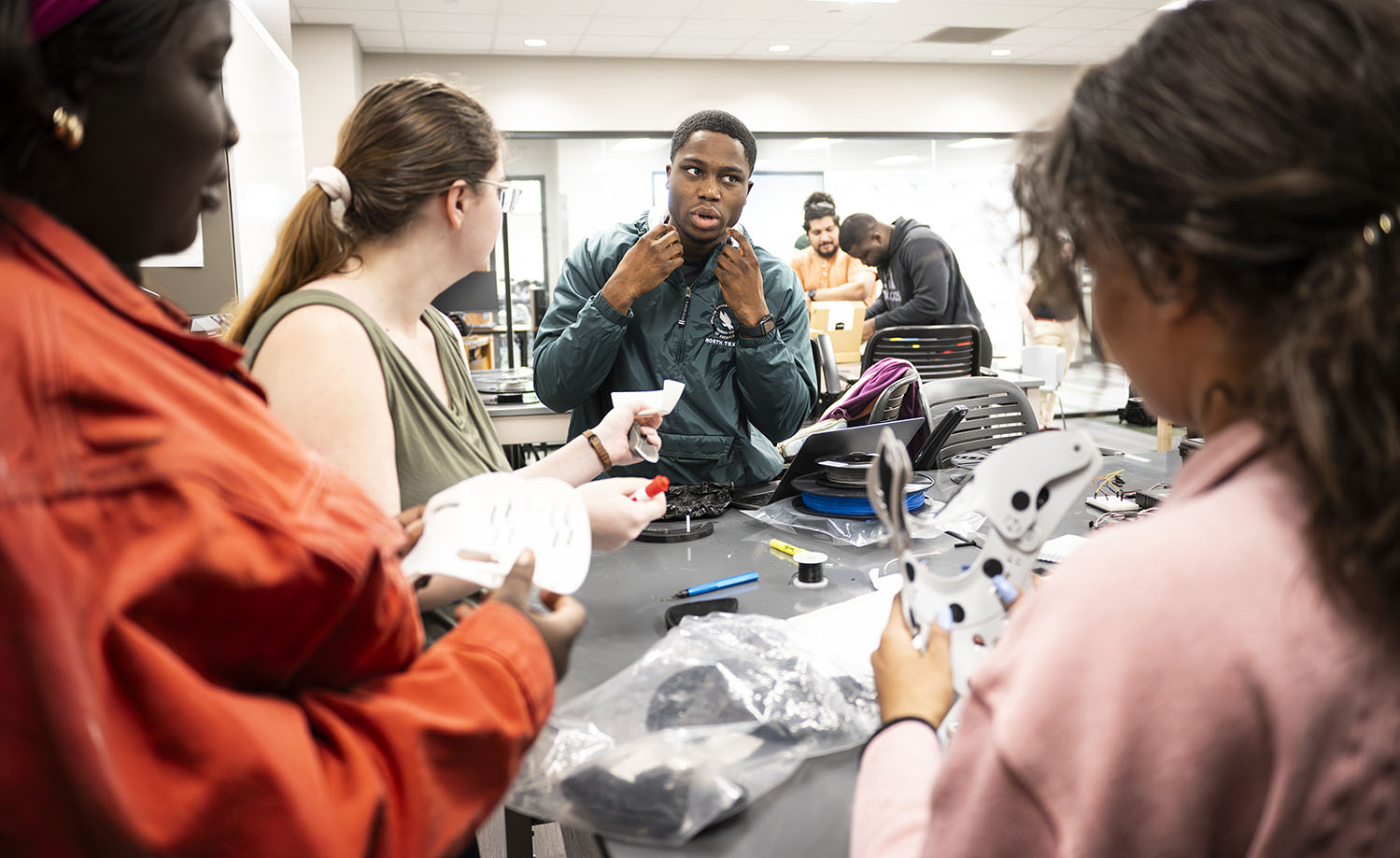 Photo of engineering students working on their neck collar senior design project 