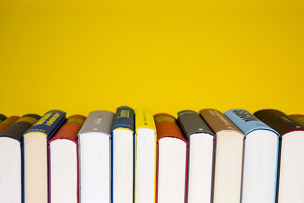 Stock photo of books on a bright yellow background